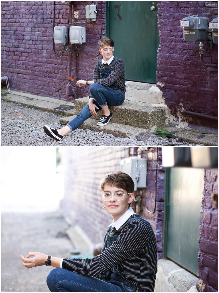 A teen sits on some stairs in an alleyway in Bay City, Michigan for her senior session with Eve Tuft Photographer