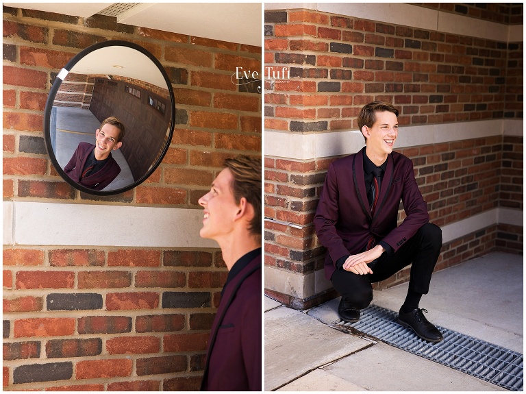 A teenage guy smiles for his session in a suit downtown | Twins senior session Midland, MI