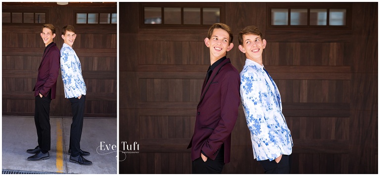 Two twin teenagers stand back to back outside in their suits | Senior Photographer in Midland, MI
