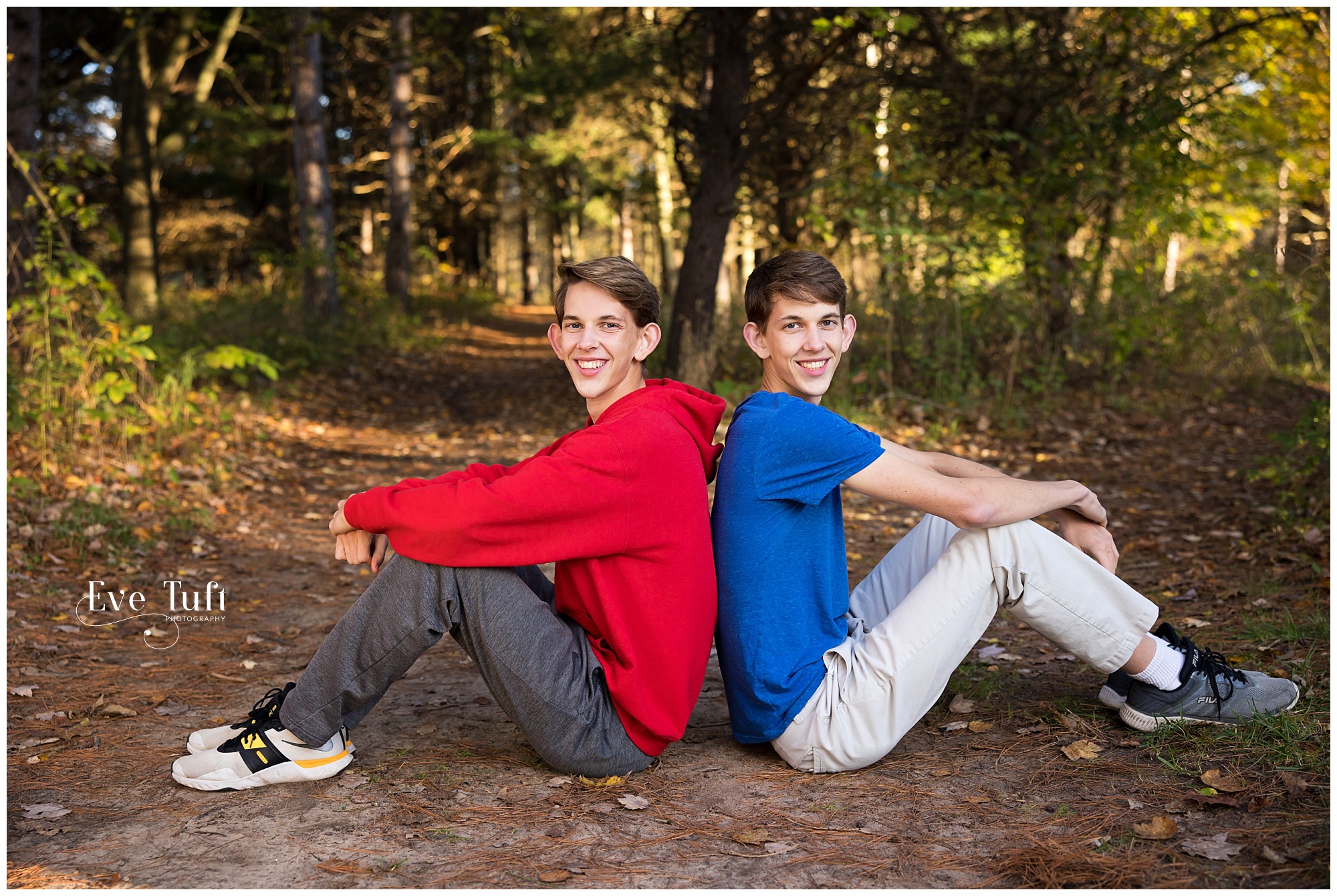 Twins lean against each other outside at the Chippewa Nature center | Midland Portrait Photographer