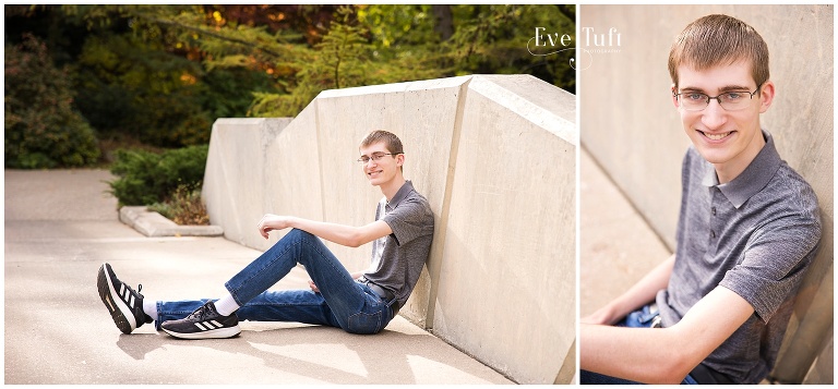 A teenage boy sits on a bridge at Dow Gardens for his senior session with Eve Tuft | Michigan Portrait Photographer