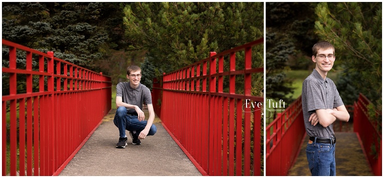 A teenage guy squats on a red bridge | Dow Gardens senior Photographer in Midland, Michigan