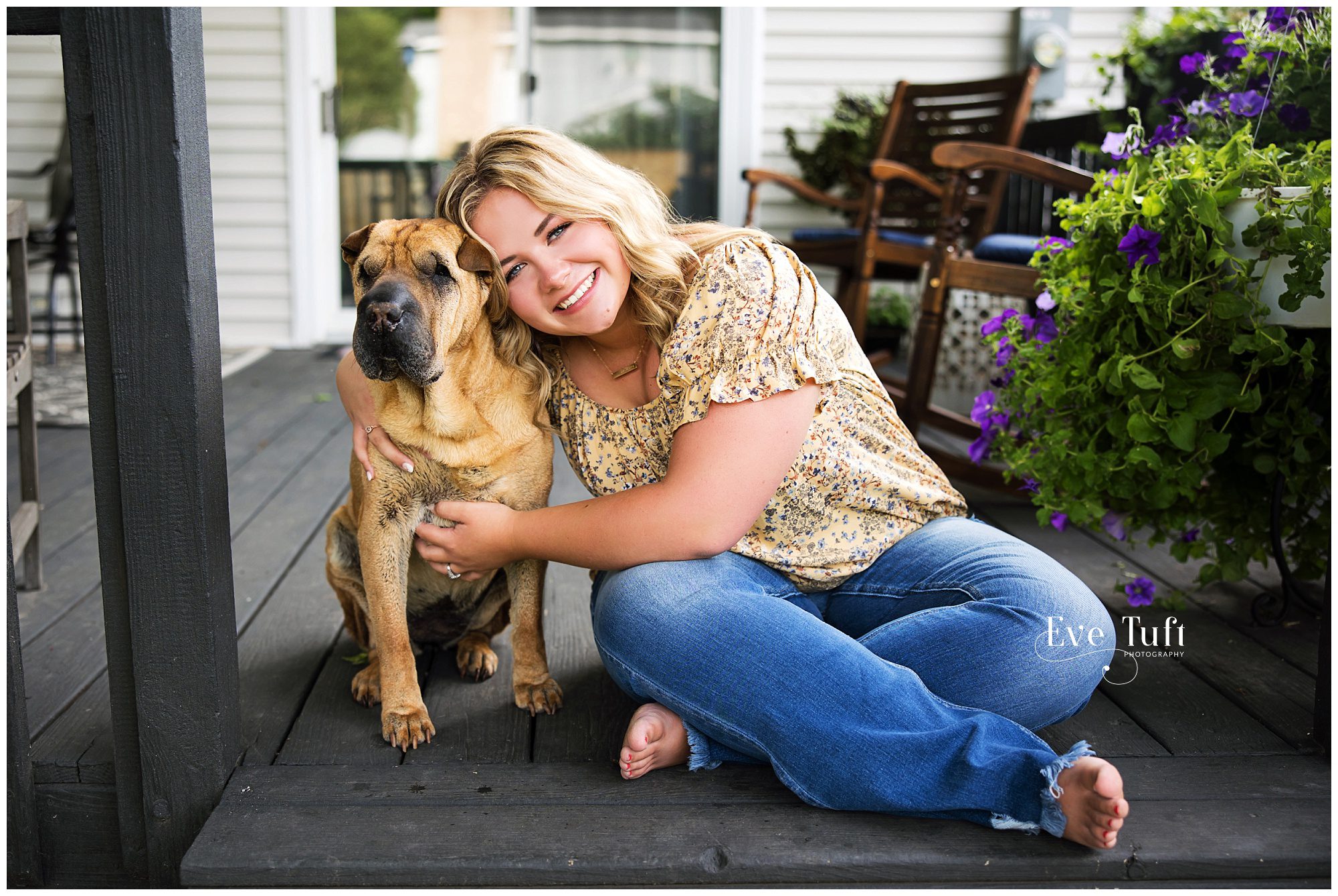 A teen snuggles her dog on her porch outside | Senior Photographer in Midland, Michigan