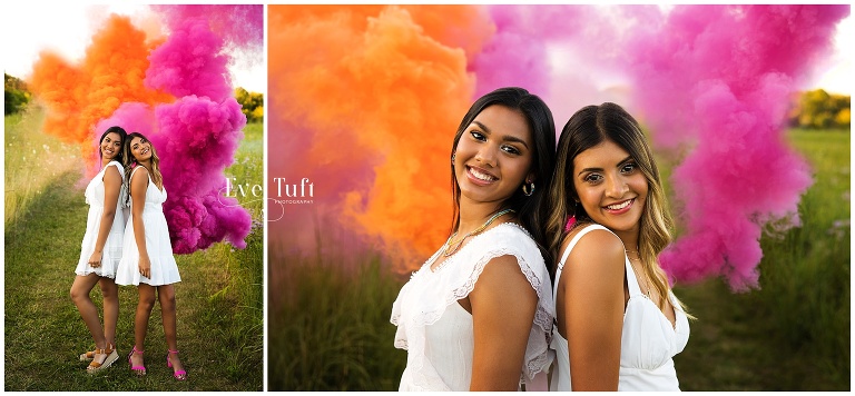 Two cousins hold colorful smoke bombs on a pathway outside | Midland, Michigan Senior Photographer