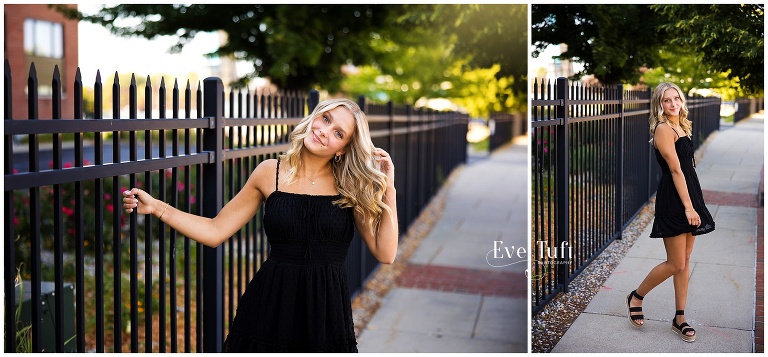 Emily holds onto a black fence outside | Senior Photographers in Bay City, MI